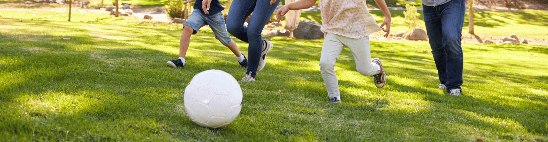 family playing soccer in Millburn park