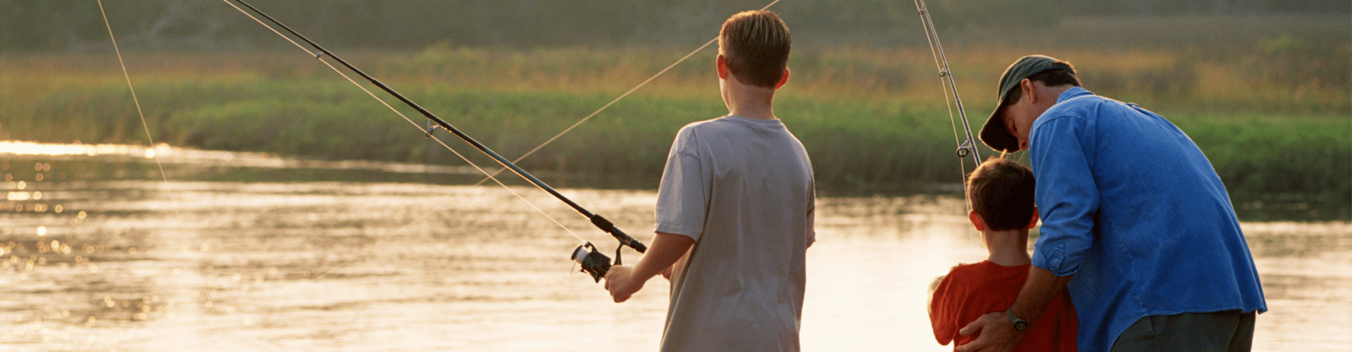 Short hills Banner man and two boysfishing at a lake in Short Hills, NJ