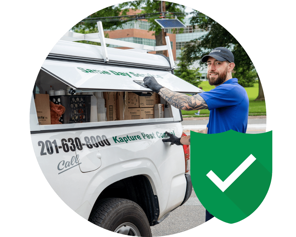 North Haledon Guarantee pest employee getting equipment out of work truck